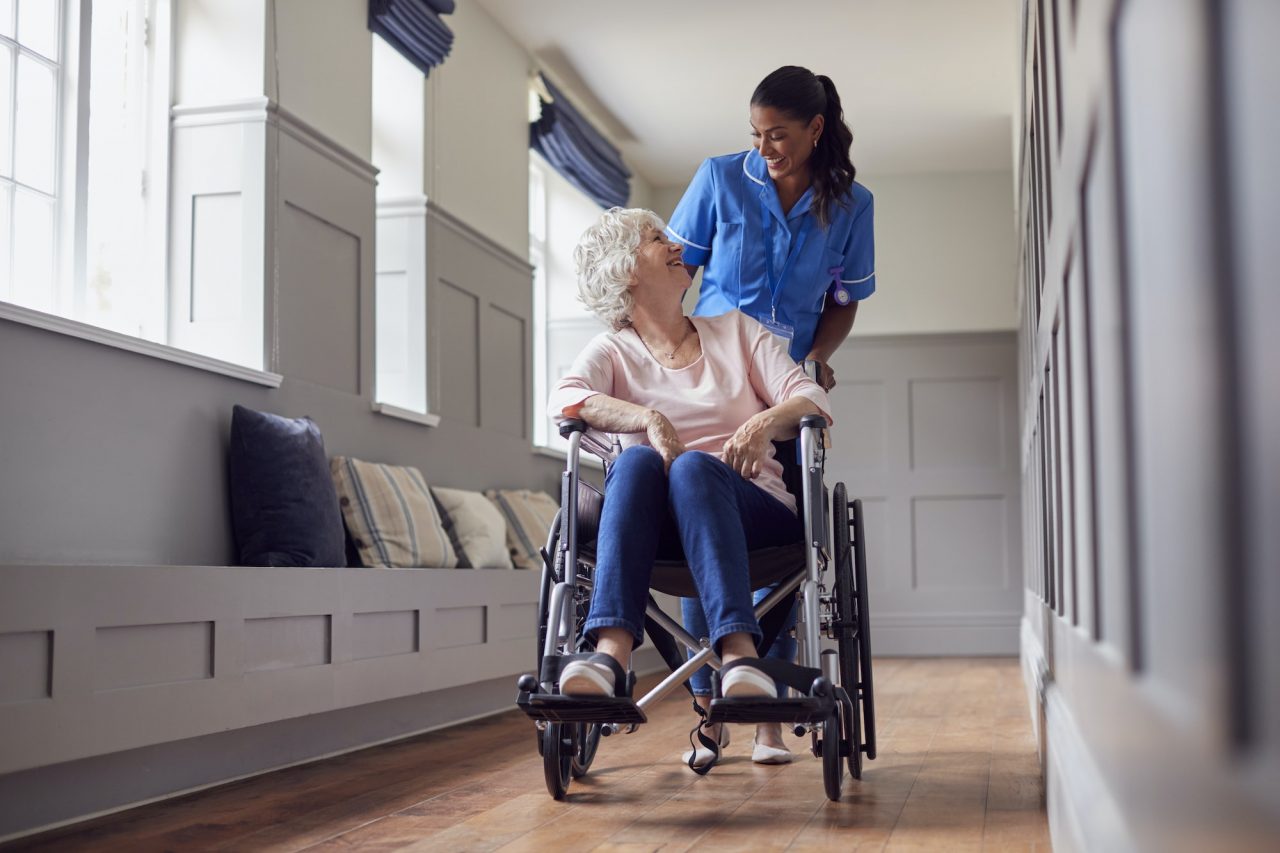 nurse pushing an elder on a wheelchair